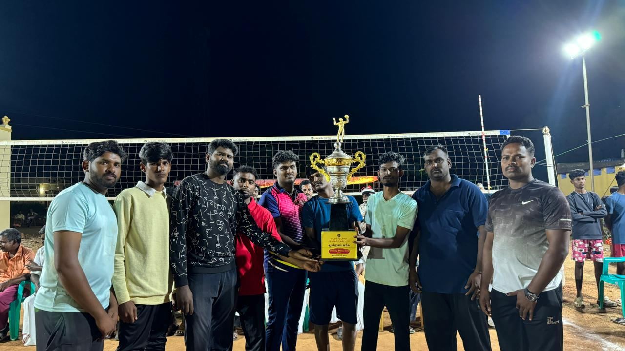 With volleyball team holding a championship trophy
